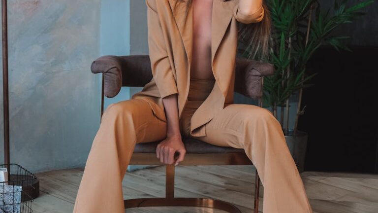 Barefoot and Shirtless Woman in Suit Sitting on Chair